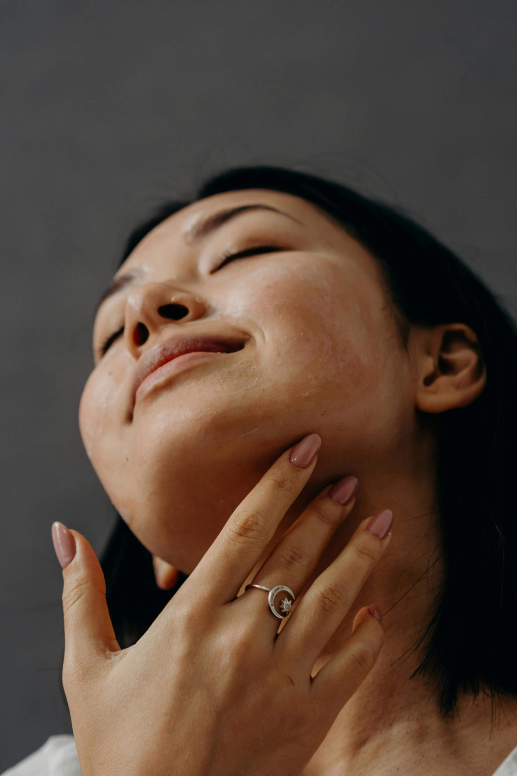Close-up of a woman assessing her skincare results timeline with a serene expression.